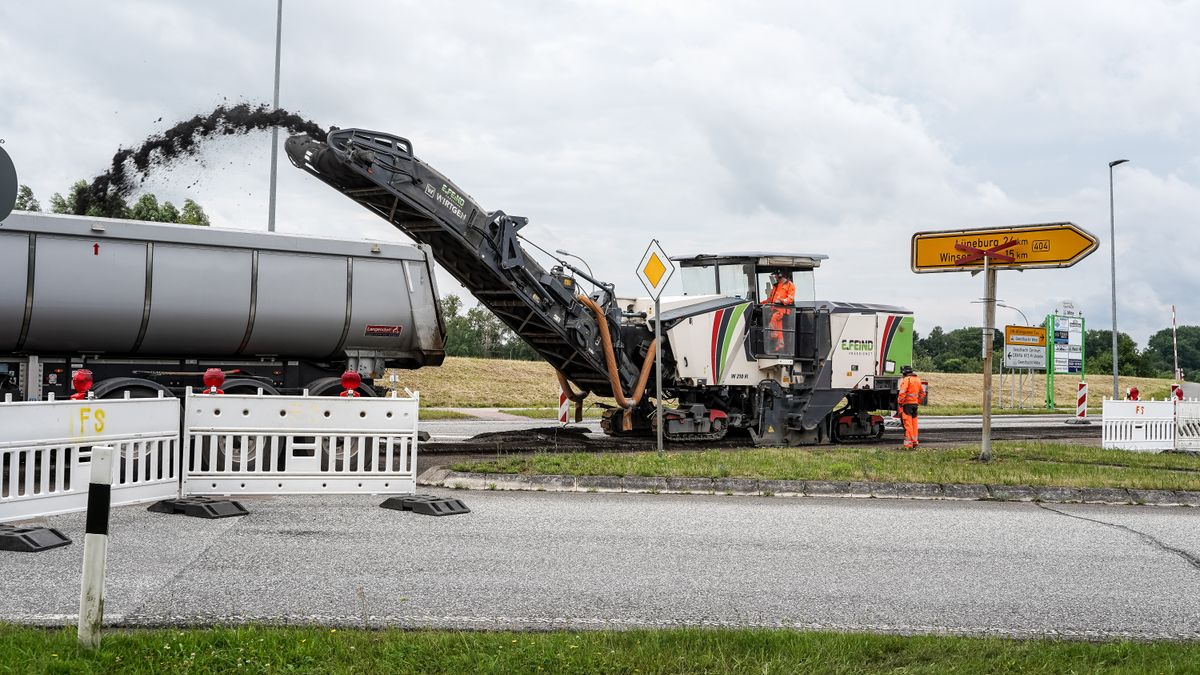Milling machine tearing out a damaged commercial parking lot ahead of full reconstruction