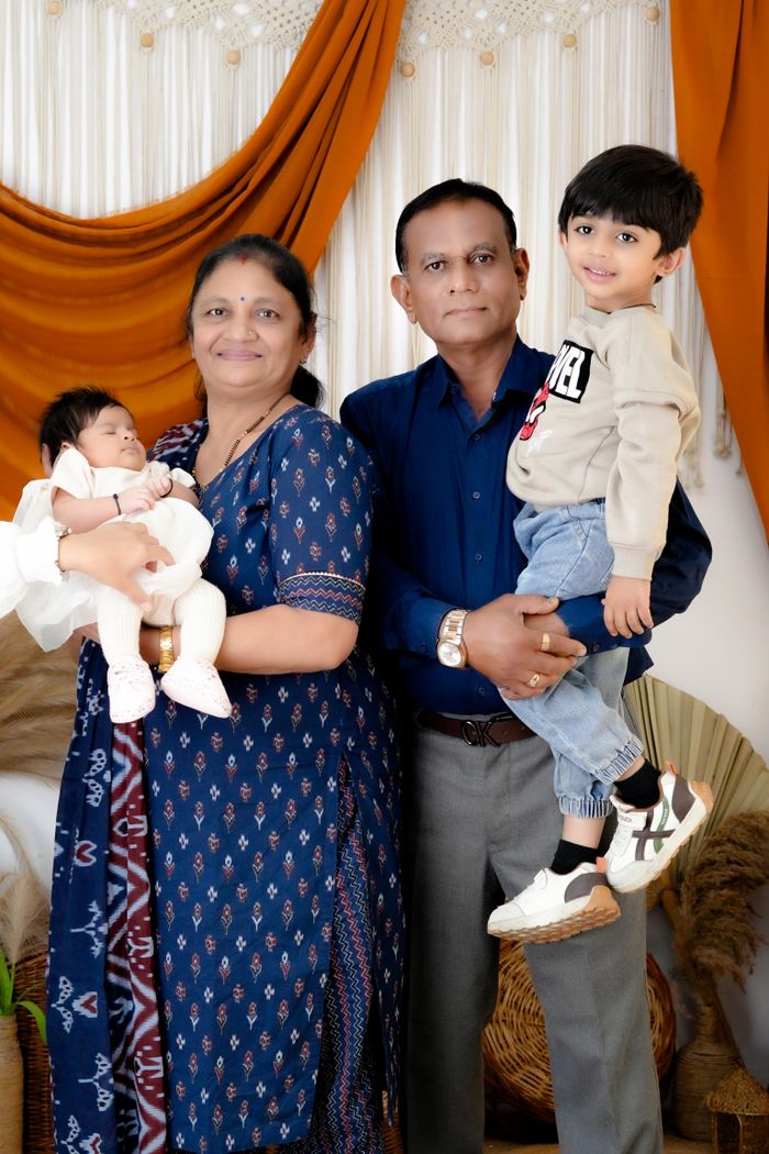 Real photo of a joint Indian family with grandparents and grandchildren in traditional clothing