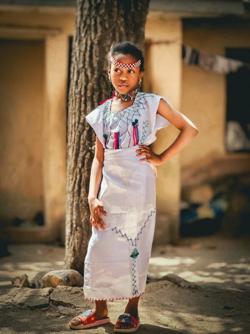 Free A girl poses confidently outdoors in traditional ethnic clothing. Stock Photo