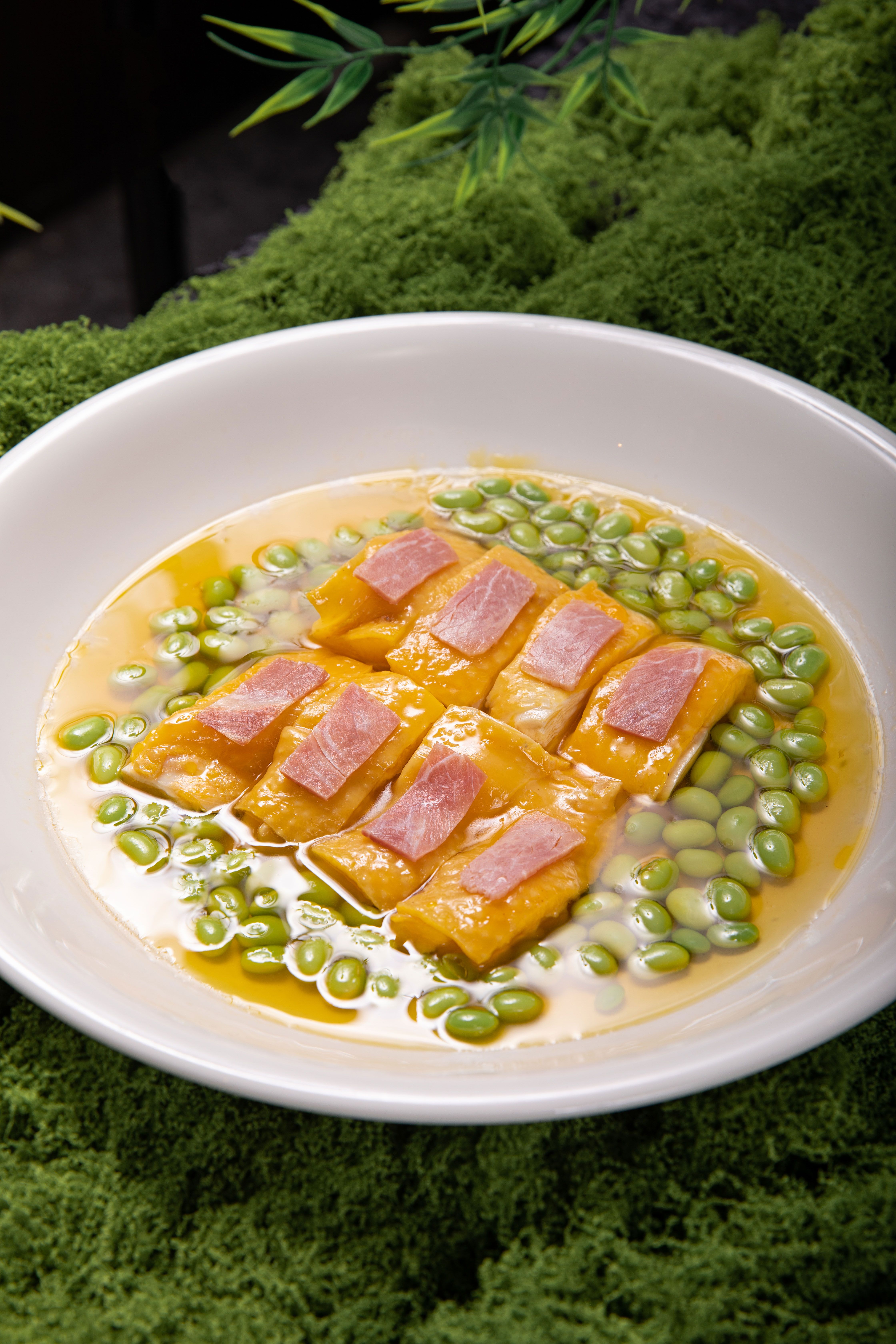 Delicious pumpkin gnocchi with ham and edamame in a savory sauce.