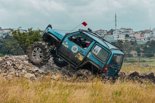 Free Exciting offroad racing scene showcasing a rugged vehicle tackling uneven terrain. Stock Photo