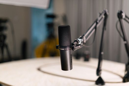Close-up of a dynamic microphone in a professional studio setting.