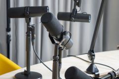 A professional podcast studio featuring dynamic microphones ready for a recording session.