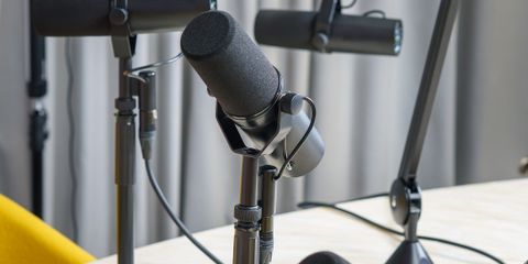 A professional podcast studio featuring dynamic microphones ready for a recording session.