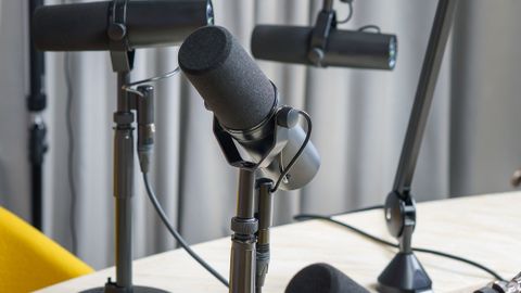 A professional podcast studio featuring dynamic microphones ready for a recording session.