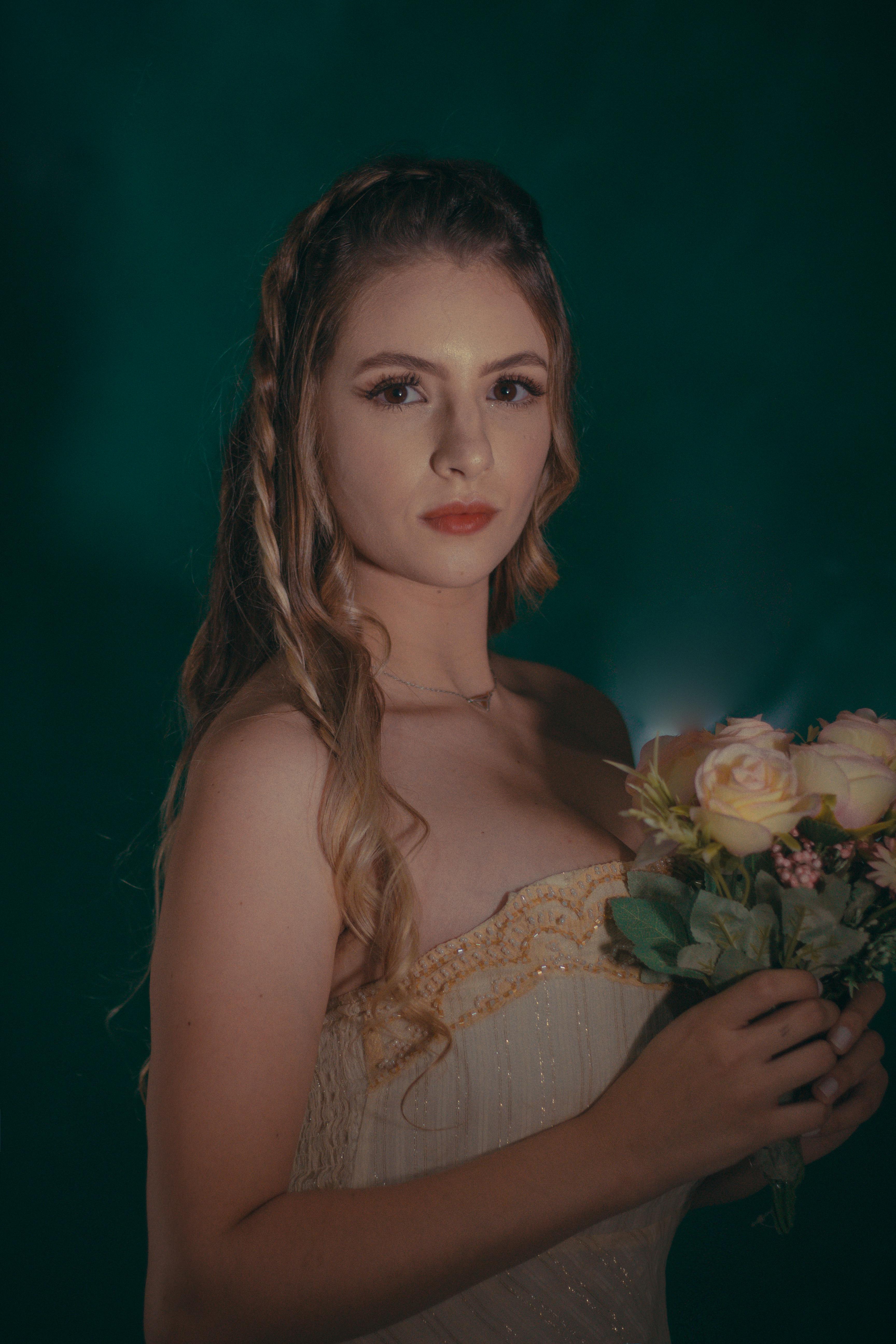 Beautiful bridal portrait with elegant hairstyle and rose bouquet, perfect for wedding inspiration.