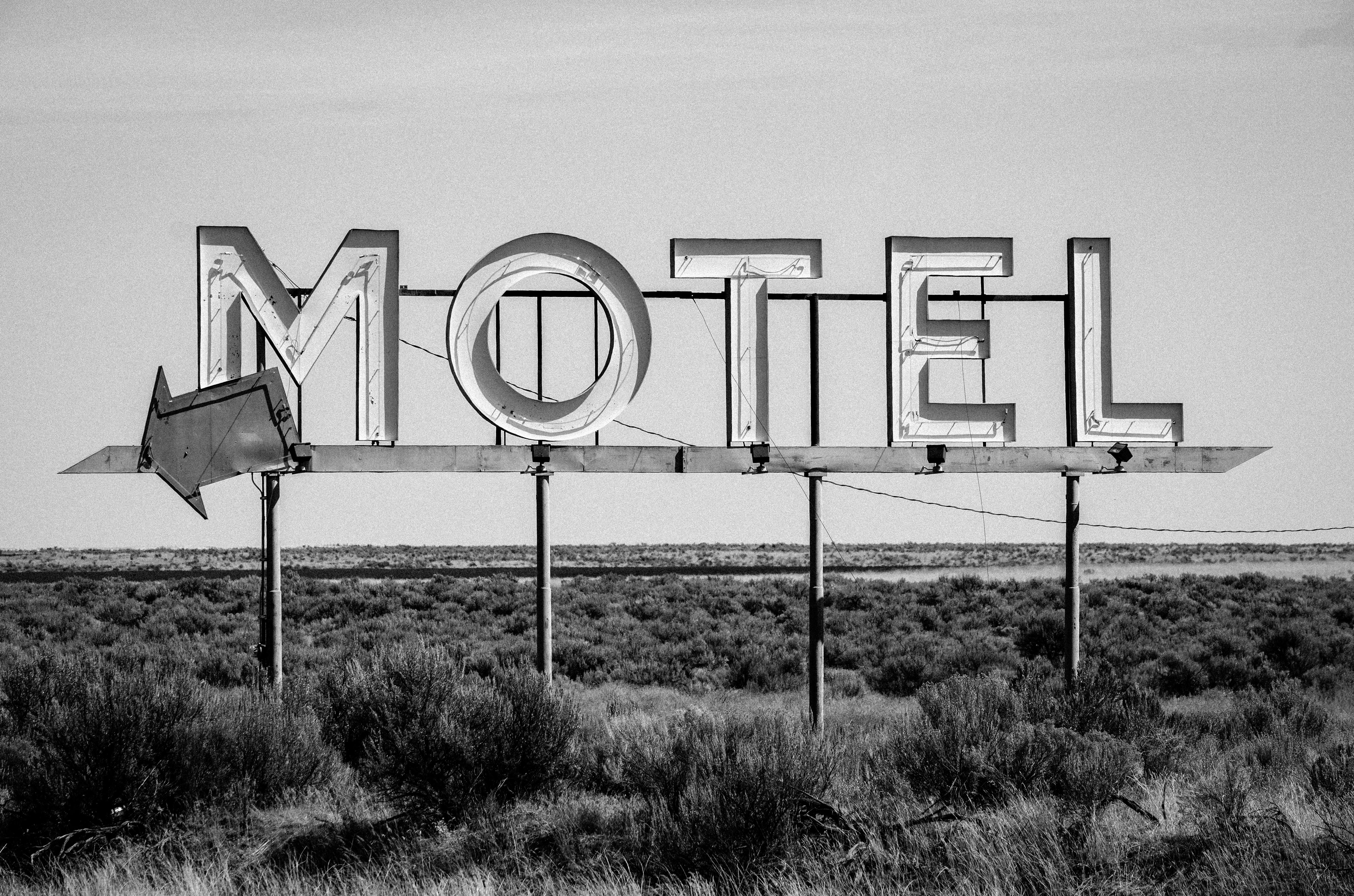 grayscale photo of motel signage