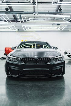 A luxury black BMW car showcased in a modern, well-lit garage setting.