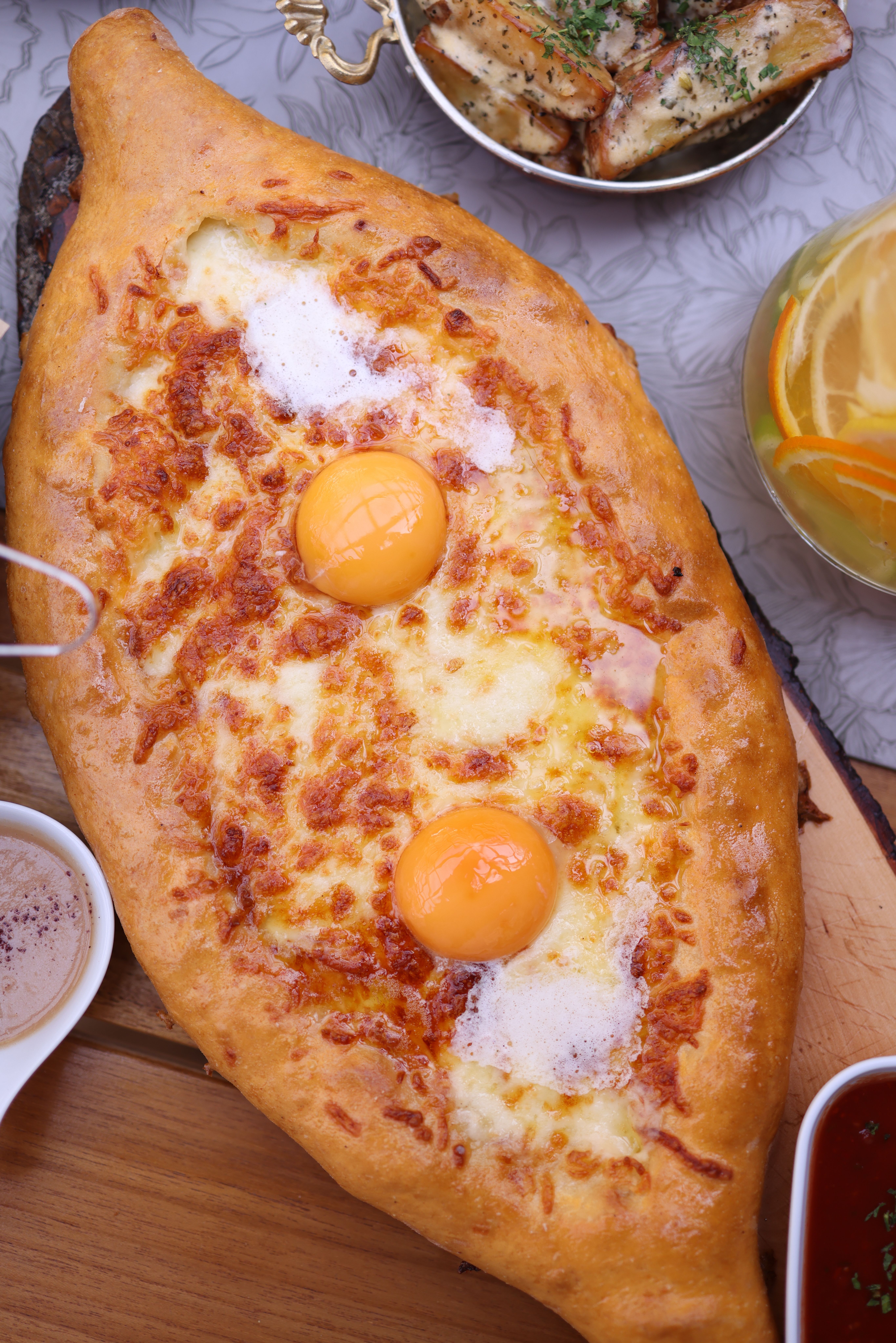 Delicious khachapuri with melted cheese and eggs. Ideal for food enthusiasts.