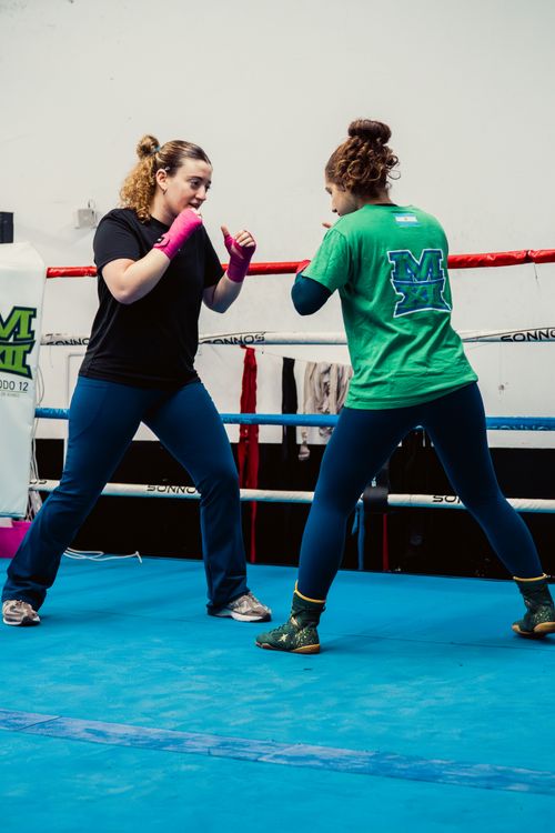 Free Two women sparring in a boxing ring at a Buenos Aires gym, showcasing intense focus and athleticism. Stock Photo
