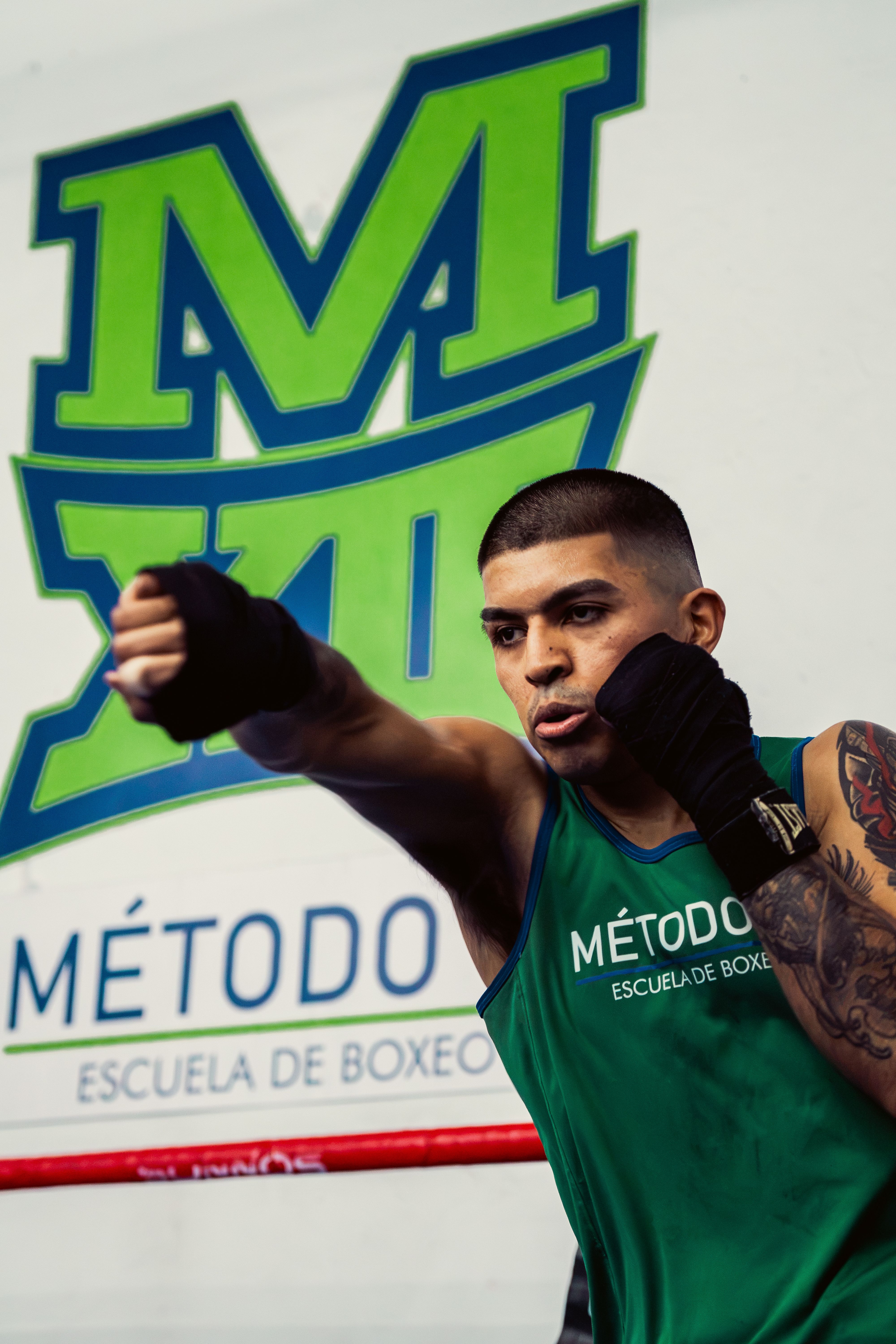 A focused boxer practicing his punch technique at Método Escuela de Boxeo in Buenos Aires.