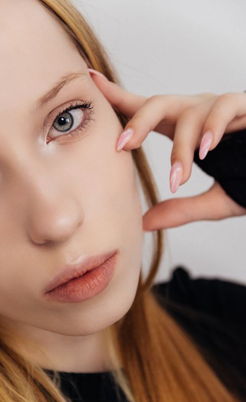 Free Intimate close-up portrait of a woman with a thoughtful expression and natural features. Stock Photo