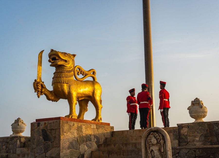 Golden lion statue and guards at Independence Memorial Square, Colombo, Sri Lanka.