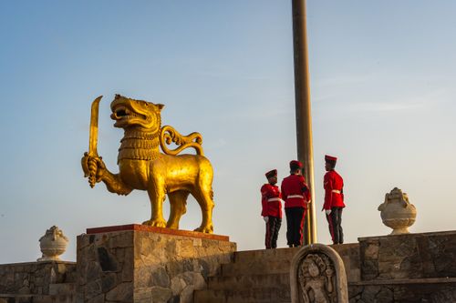 Free Golden lion statue and guards at Independence Memorial Square, Colombo, Sri Lanka. Stock Photo