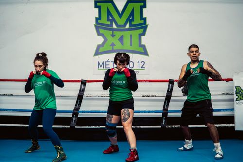 Free Three individuals engaged in a boxing training session at Método 12 gym in Buenos Aires, Argentina. Stock Photo