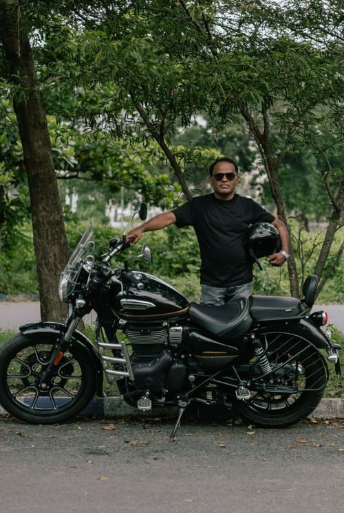 Free Man posing with his motorcycle outdoors in Kolkata, India Stock Photo
