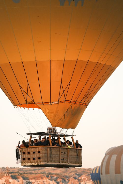 Free A breathtaking hot air balloon ride over Cappadocia, Turkey at sunrise, capturing stunning rock formations. Stock Photo