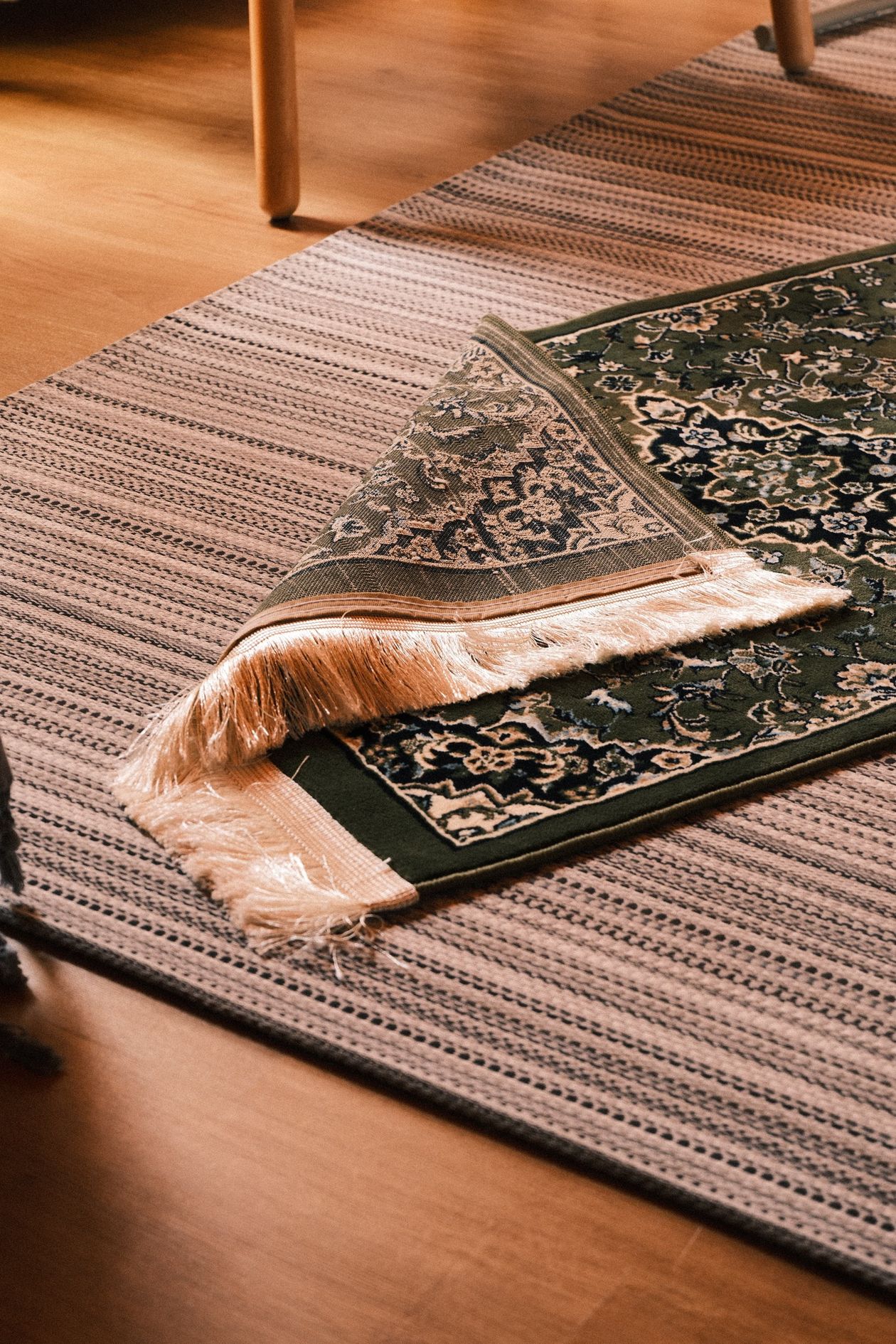 how to rotate area rugs by season: layered rugs in a cozy living room