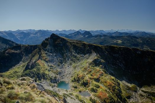 Breathtaking aerial view of rugged Alpine mountains with clear blue skies.