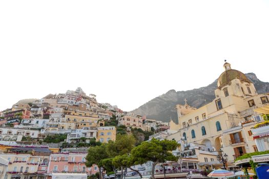 Scenic view of Positano's colorful hillside architecture and iconic church on the Amalfi Coast.