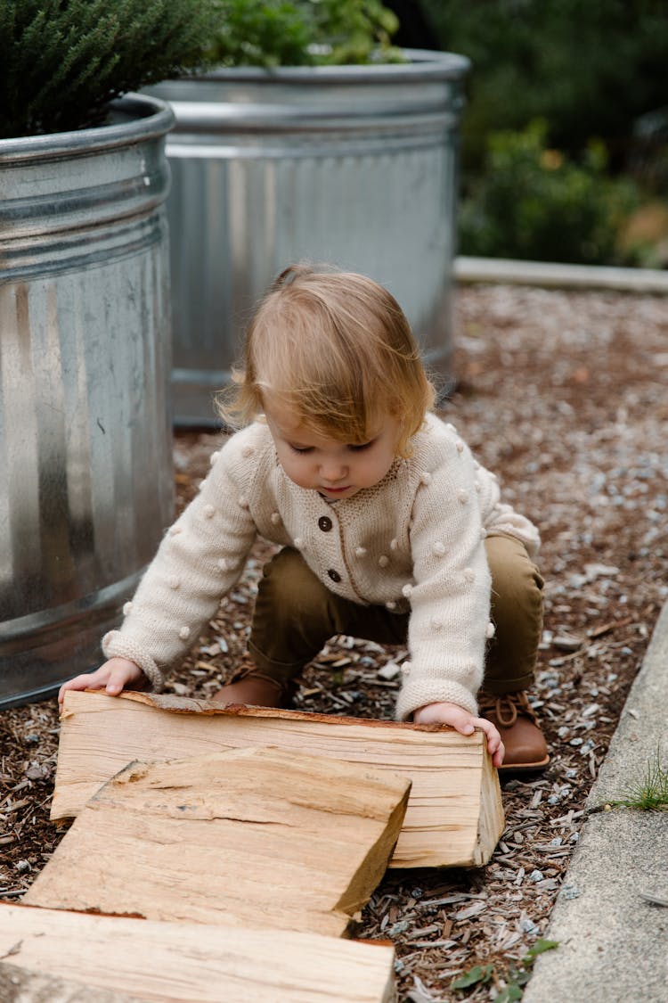 Kid Putting Firewood  On Ground During Game