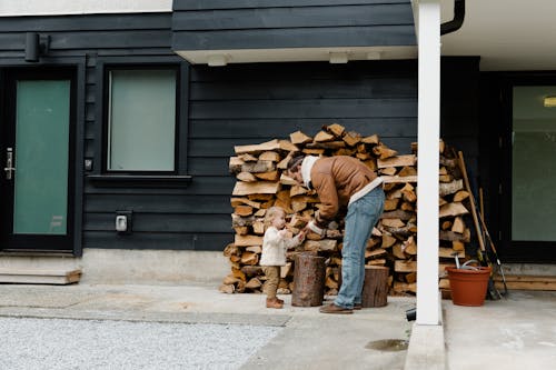 Man Showing Firewood to Little Girl