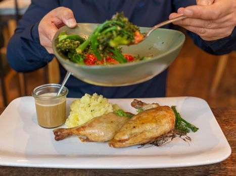 A savory plate of roasted chicken with mashed potatoes, gravy, and steamed vegetables, perfect for any meal.