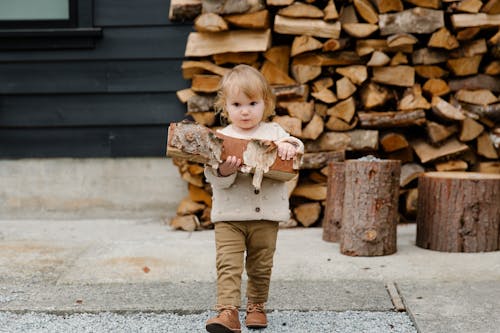 Girl Holding Wooden Logs
