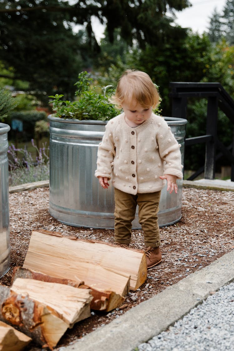 Girl Near Wooden Logs