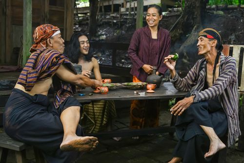 Free A group of adults enjoying a traditional Javanese meal outdoors in Central Java. Stock Photo