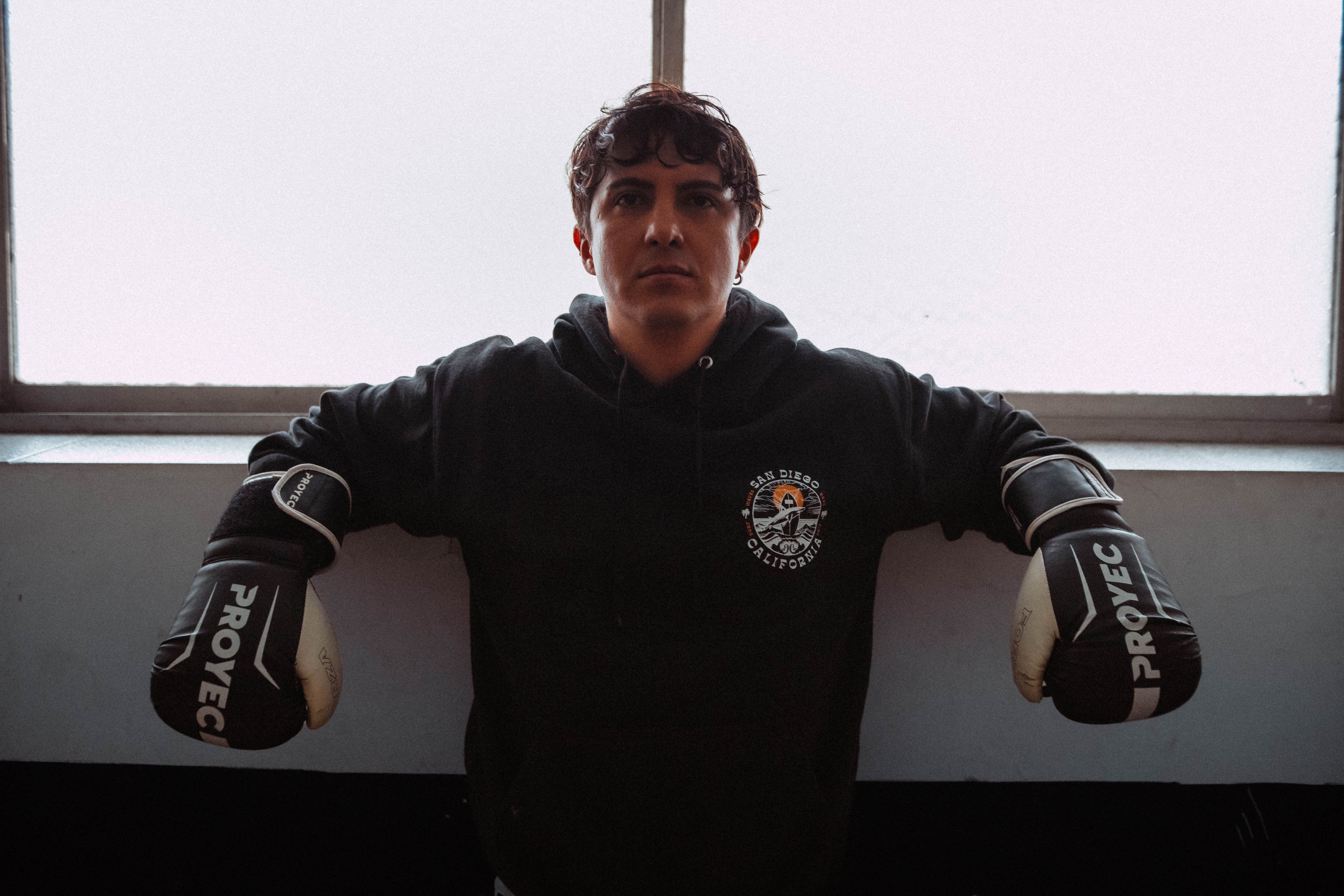 Focused young boxer in gloves poses indoors in Buenos Aires, Argentina.