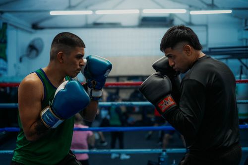 Free Two boxers face off in a Buenos Aires gym, focusing intensely on the sport. Stock Photo