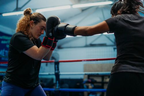 Free Two women engaged in a sparring session in a boxing gym in Buenos Aires. Stock Photo