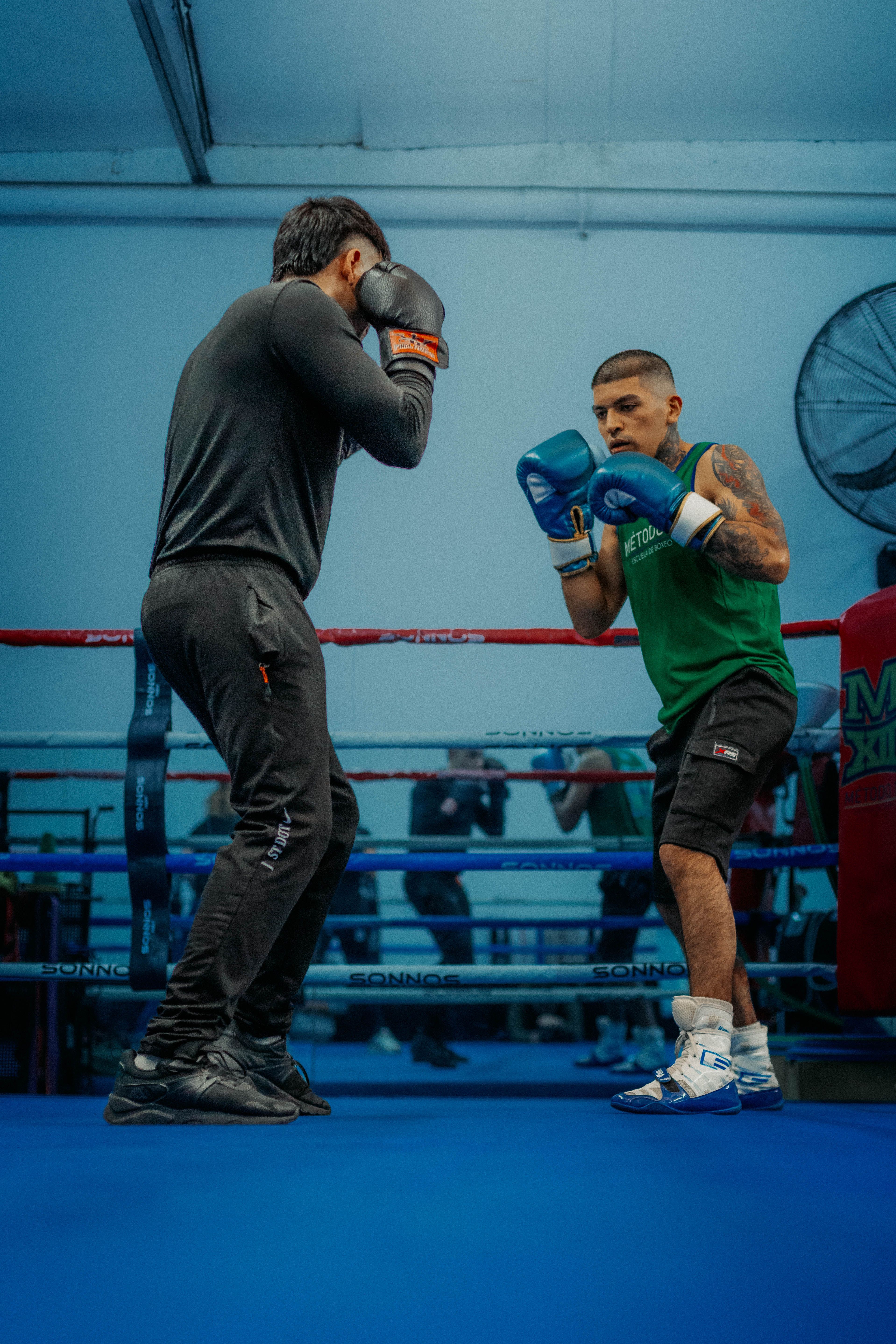 Two boxers sparring inside the ropes.