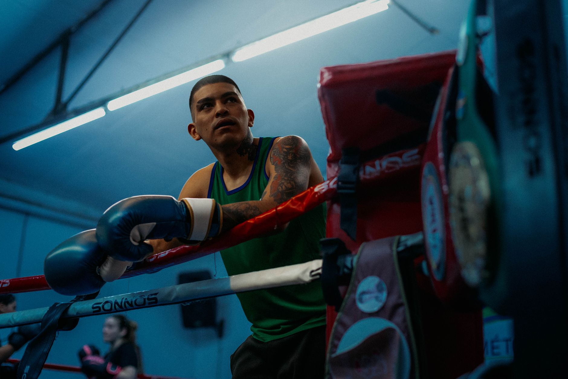 A focused boxer rests in the gym's corner during training in Buenos Aires.