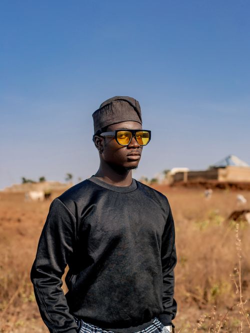 Free Young man wearing stylish sunglasses and traditional hat outdoors. Stock Photo