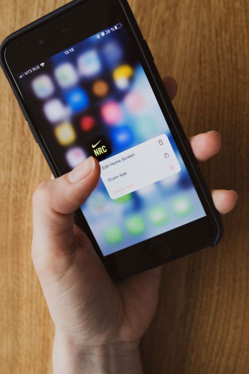 Close-up of a person touching a smartphone screen while using an app