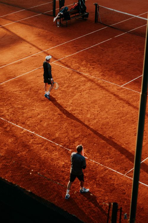 Free Two tennis players on a clay court in Buenos Aires, captured from above, during a day match. Stock Photo