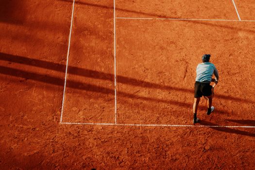 Aerial view of a tennis player in action on a clay court in Buenos Aires.