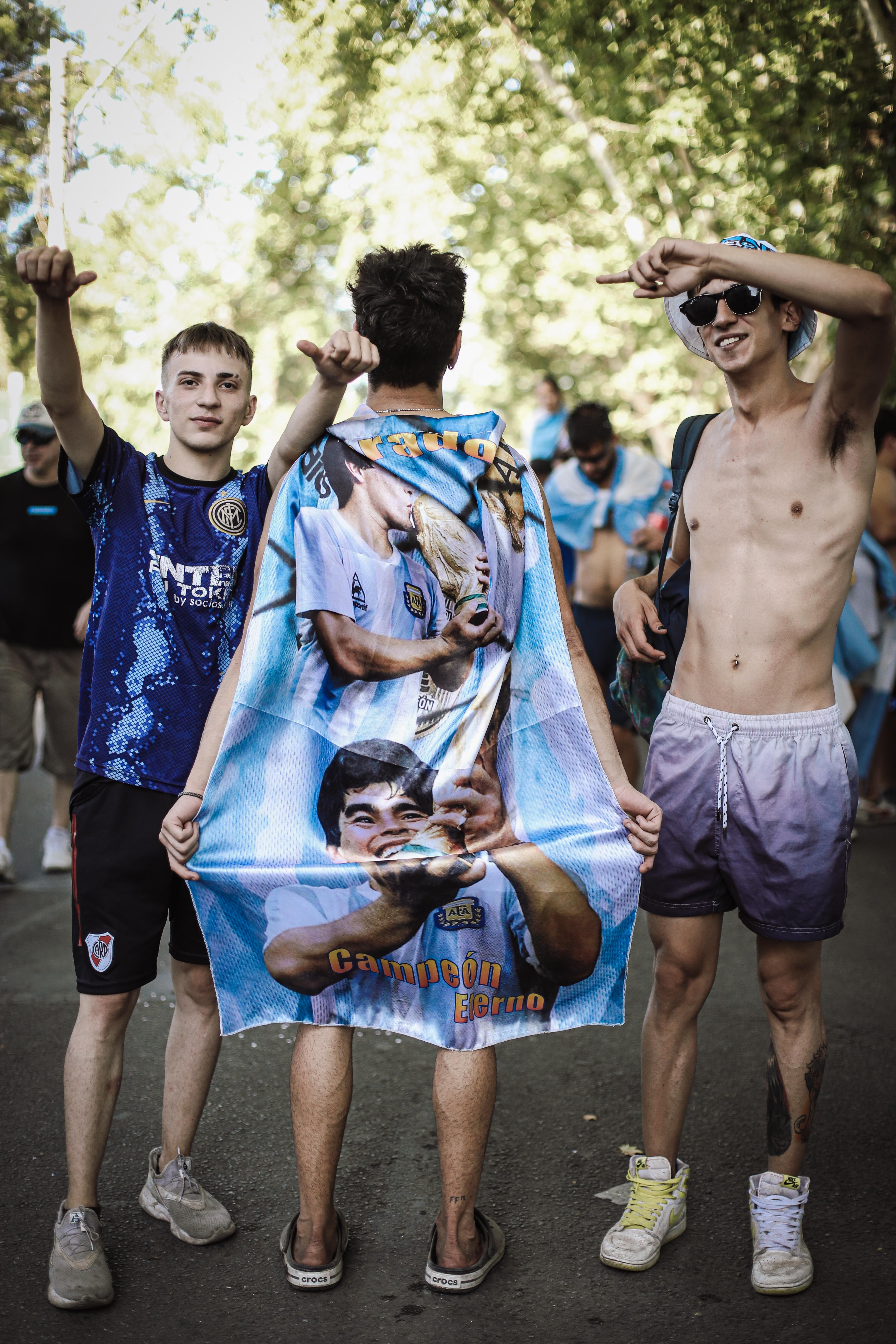 Young soccer fans celebrate with a Maradona-themed flag in Buenos Aires.