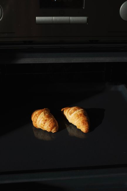 Delicious freshly baked croissants in a home oven, ready to serve.