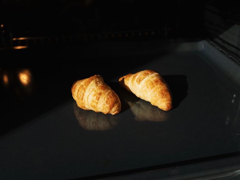 Testing a repaired oven Freshly baked croissants in an oven