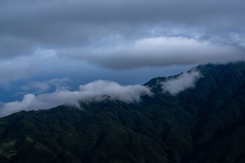 Free Dramatic mountain landscape with low clouds and mist enveloping the peaks. Stock Photo