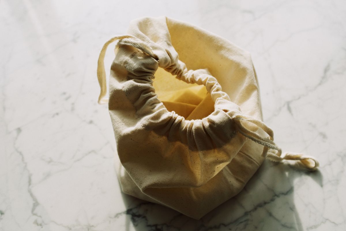 Natural cotton seed bags displayed in a row showing biodegradable and reusable packaging made from organic cotton