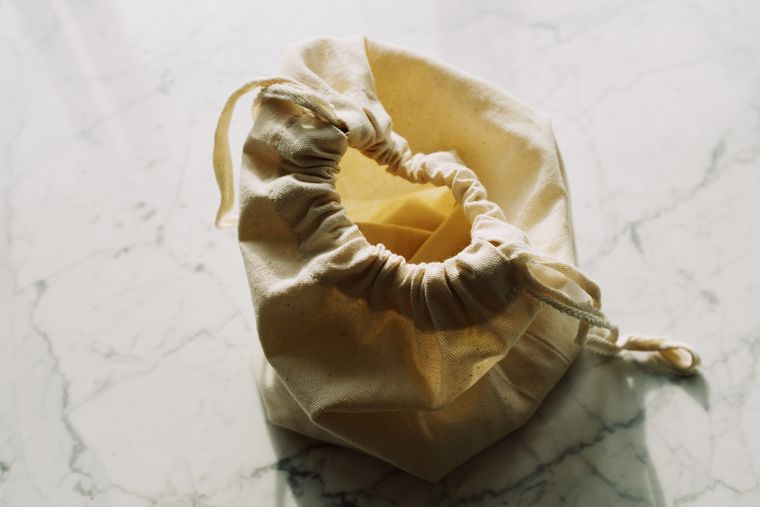Small textile drawstring bag on a pale surface - photo by ready made on Pexels