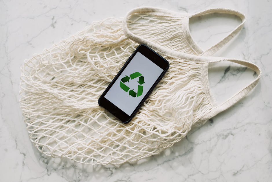 White mesh bag with smartphone placed on white surface in light room