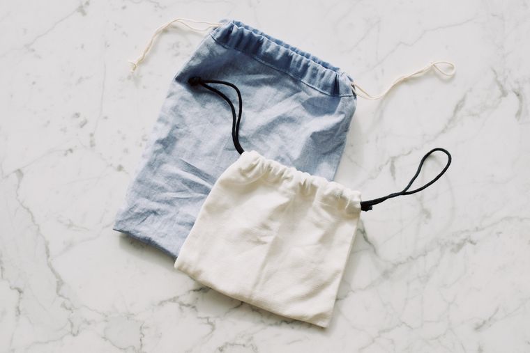 Pair of blue and white textile bags with drawstrings, seen from above - photo by ready made on Pexels