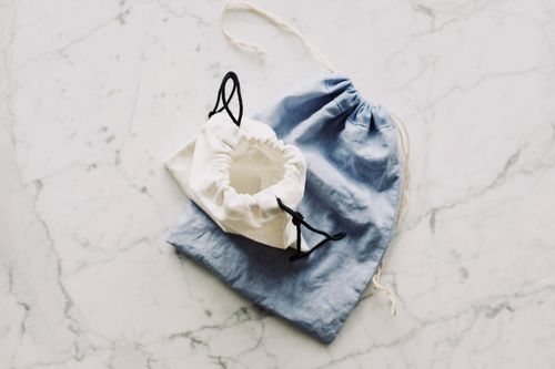 Free Top view of blue and white textile bags placed on each other on marble surface in room Stock Photo