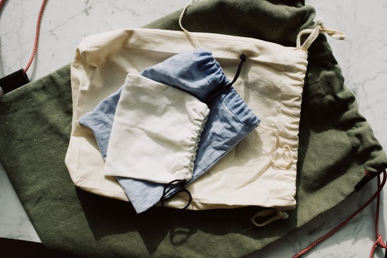 Set of folded fabric pouches arranged on a marble surface - photo by ready made on Pexels