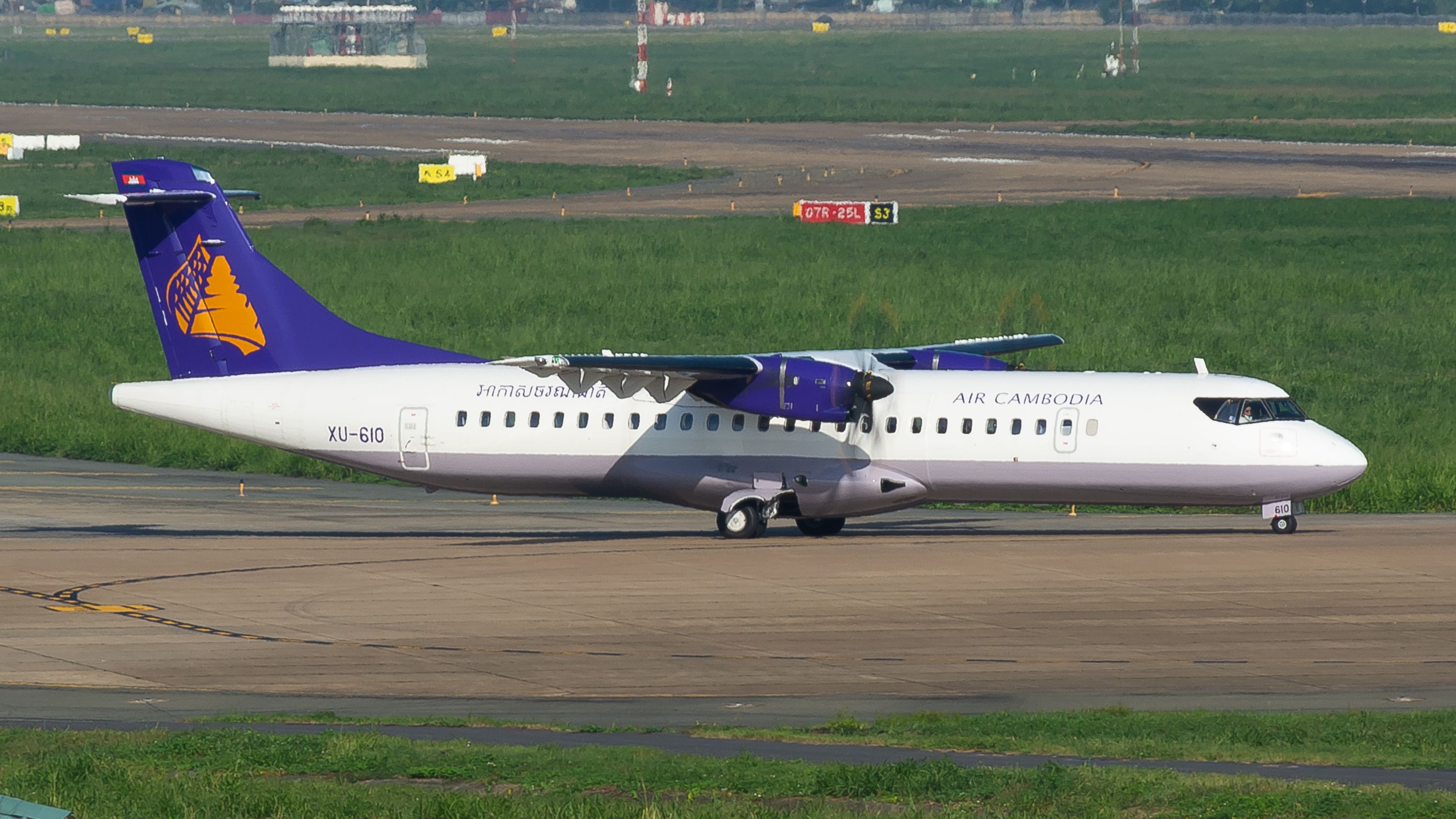 ATR 72 aircraft operated by Air Cambodia parked on an airport tarmac, ready for departure.